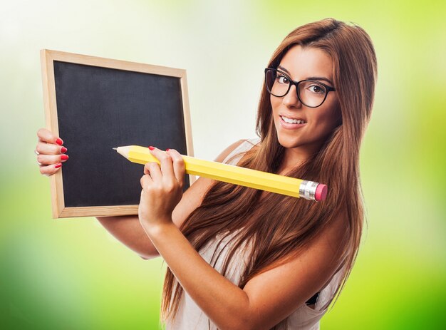 Woman with big pencil and small blackboard