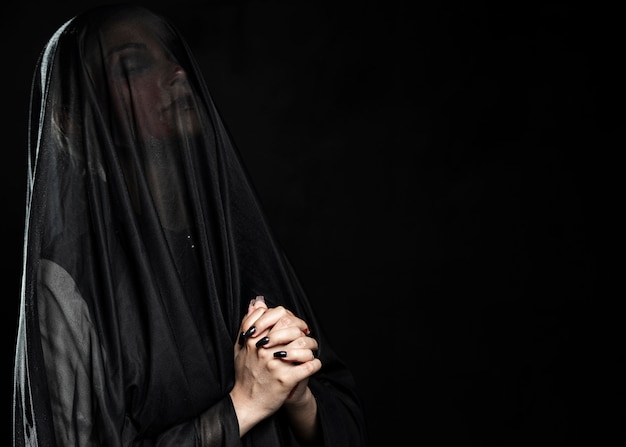Woman with black veil and copy space