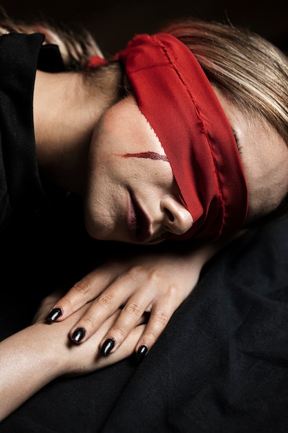 Free photo woman with blindfold lying her head