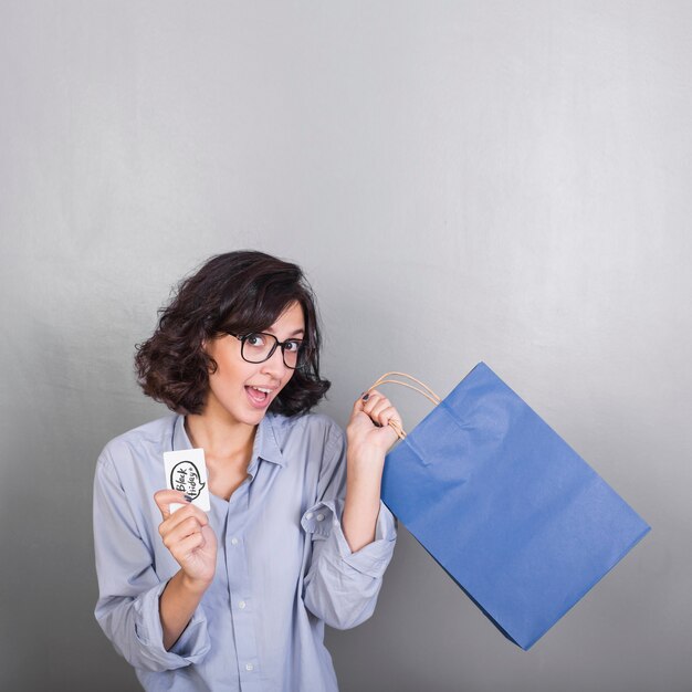 Woman with blue shopping bag and credit card 