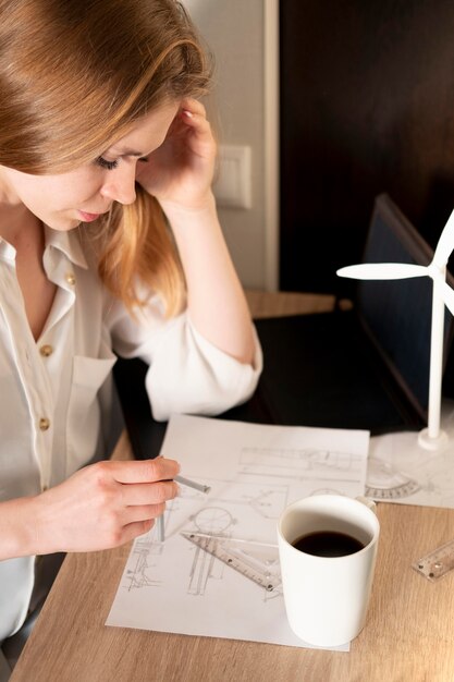 Woman with blueprints working