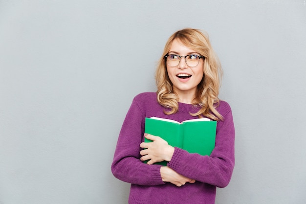 Woman with book looking away