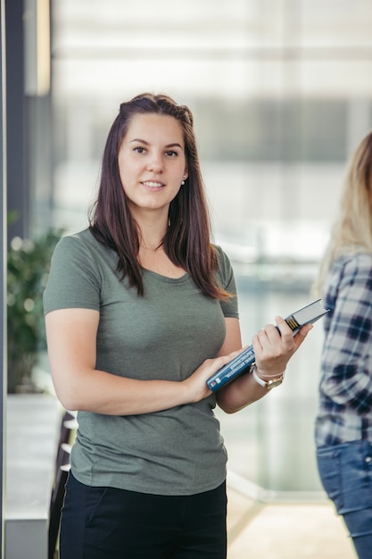 Woman with book looking at camera