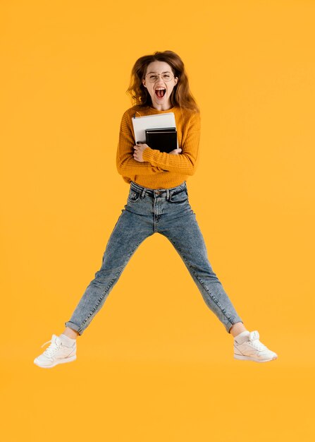 Woman with books jumping