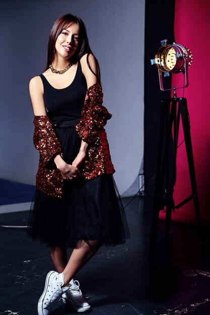 Woman with brightly blazer posing