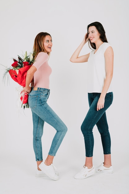 Woman with bunch of flowers for girlfriend