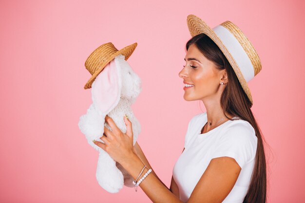 Donna con il giocattolo del coniglietto su fondo rosa