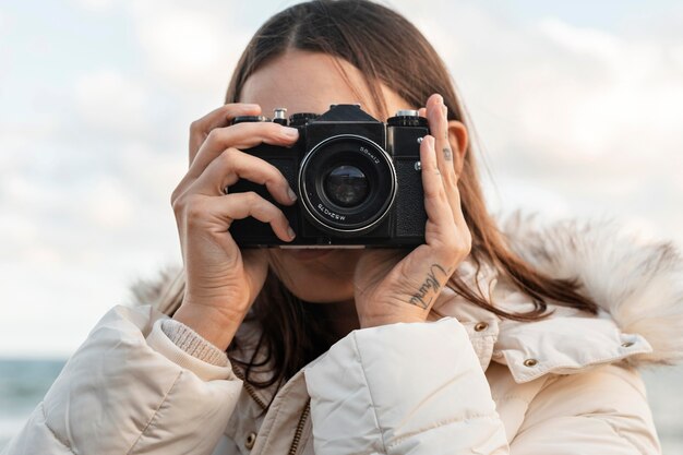 Woman with camera at the beach