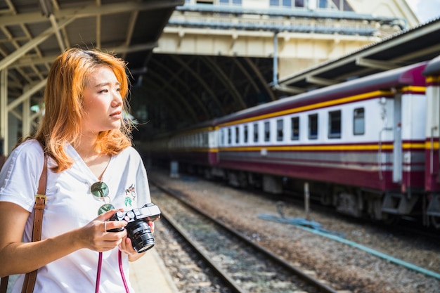 Woman with camera on depot