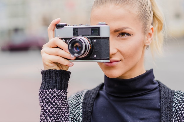 Free photo woman with camera on street