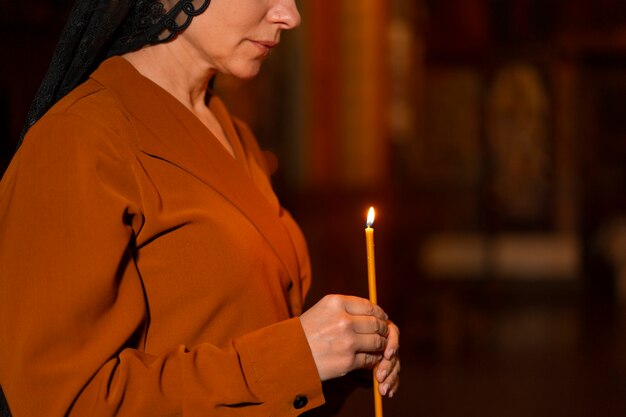 Woman with candle at the church