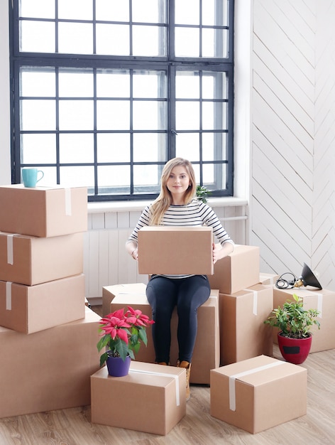 Woman with cargo packages ready to shipping or moving