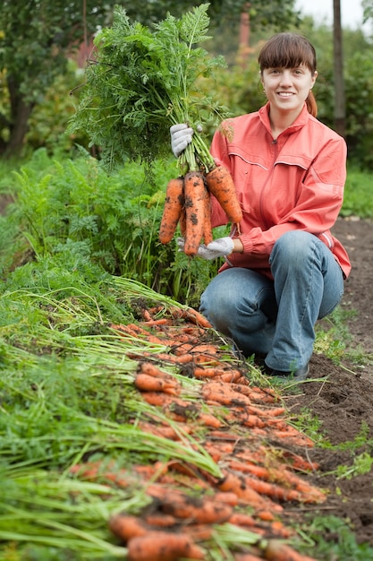 woman with carrot harvest