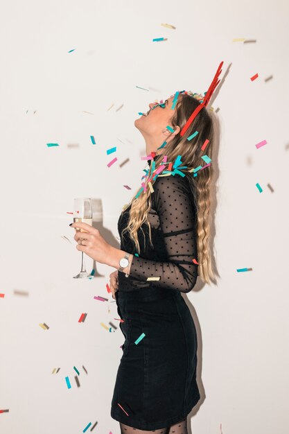 Woman with champagne glass under spangles