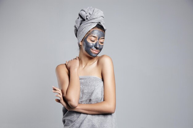 Woman with clay cleansing facial mask