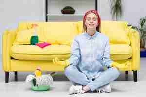 Free photo woman with cleaning gloves doing yoga