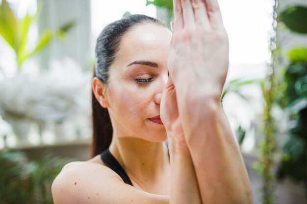 Woman with closed eyes in eagle pose