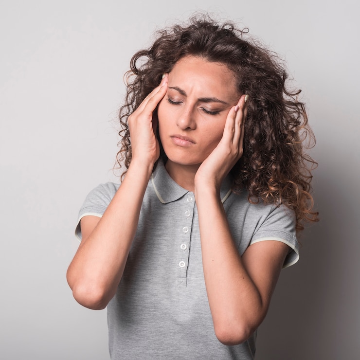 Free Photo woman with closed eyes having headache against gray background