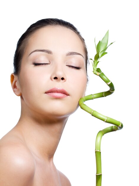 Woman with closed eyes with plant