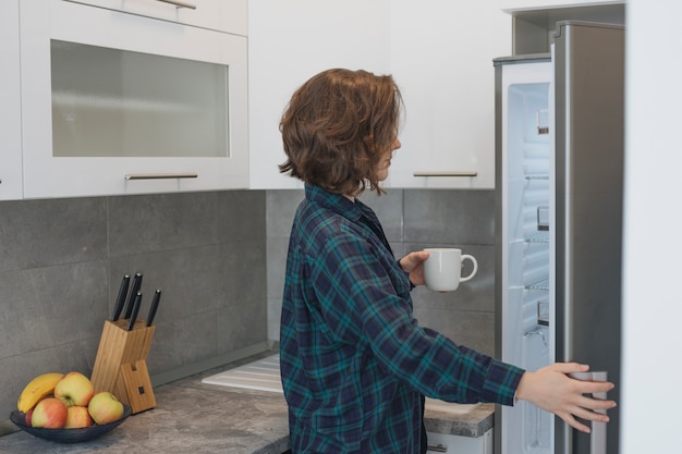 Woman with coffee cup at home