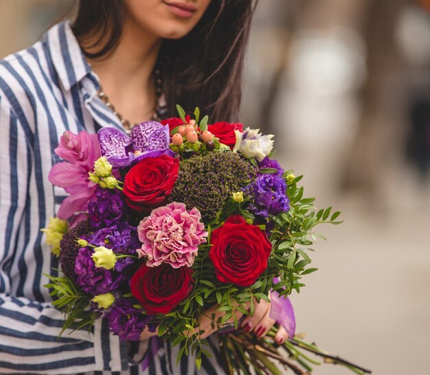 Woman with a colorful bouquet in the street