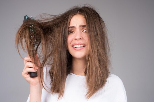 Woman with comb and problem hair hair care and hair loss concept