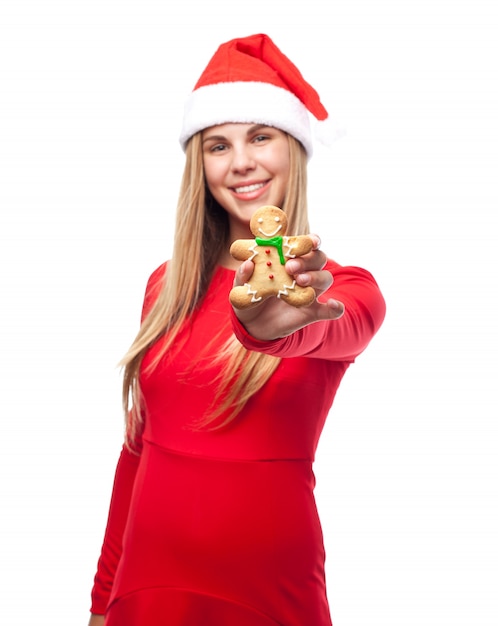 Woman with a cookie person and santa's hat