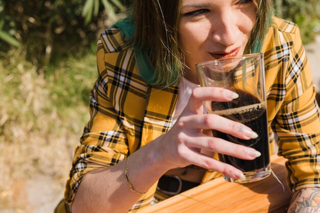 Woman with craft beer outdoors