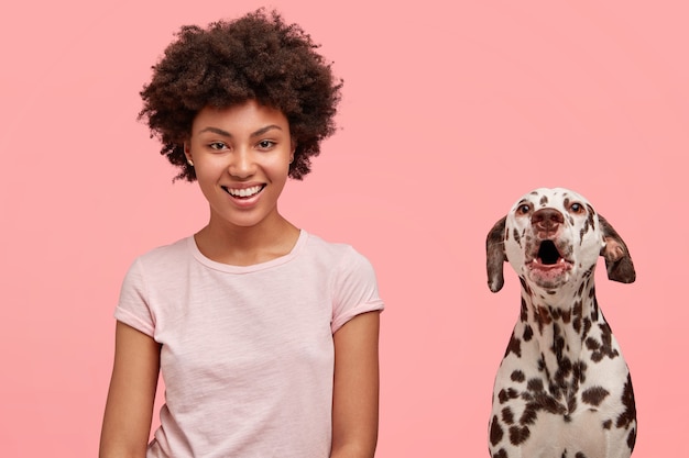 Woman with curly hair and her dalmatian dog