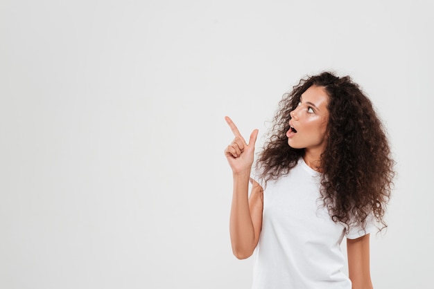 Woman with curly hair pointing finger away
