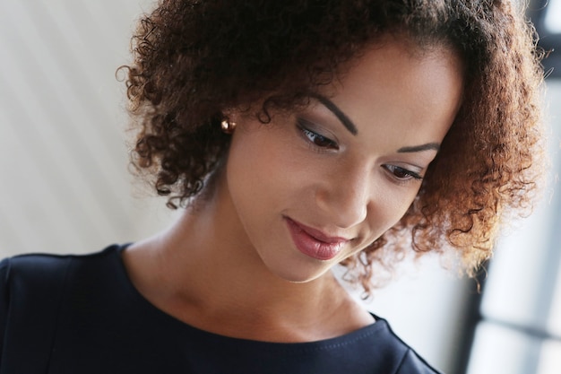 Woman with curly hair and smiling