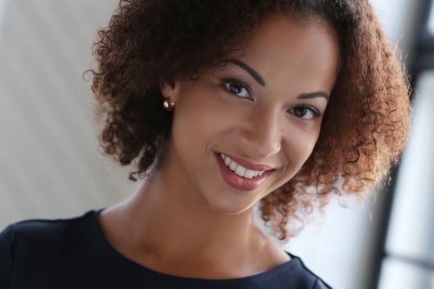 Woman with curly hair and smiling