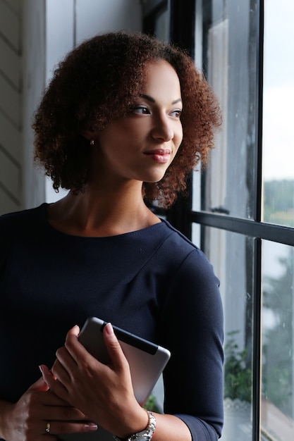 Woman with curly hair using a tablet