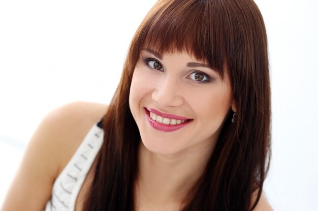 Woman with dark hair is posing