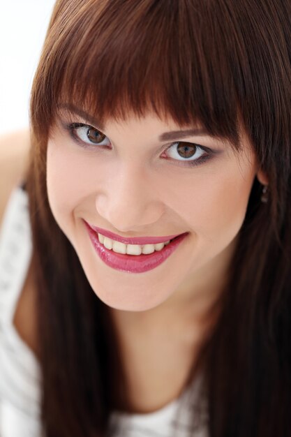 Woman with dark hair is posing