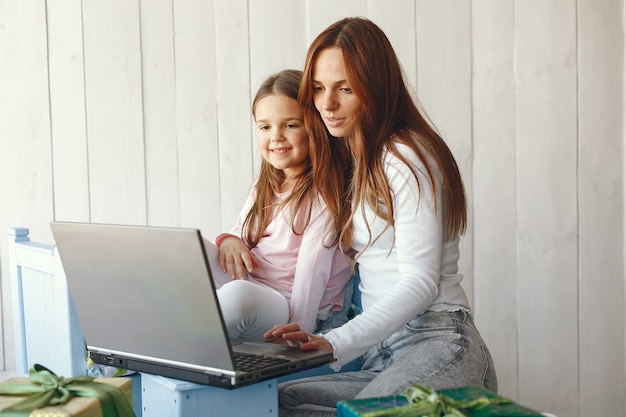 Free photo woman with daughter using laptop computer