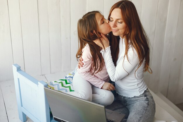 Woman with daughter using laptop computer