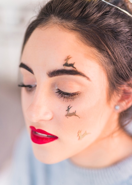 Woman with deer spangles on face