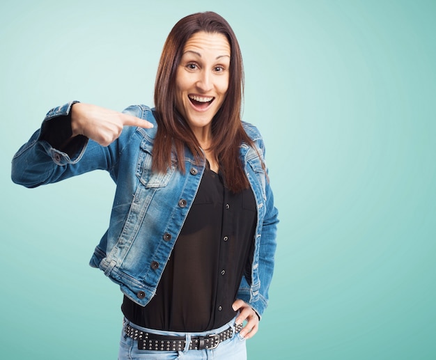 Woman with denim jacket pointing at herself