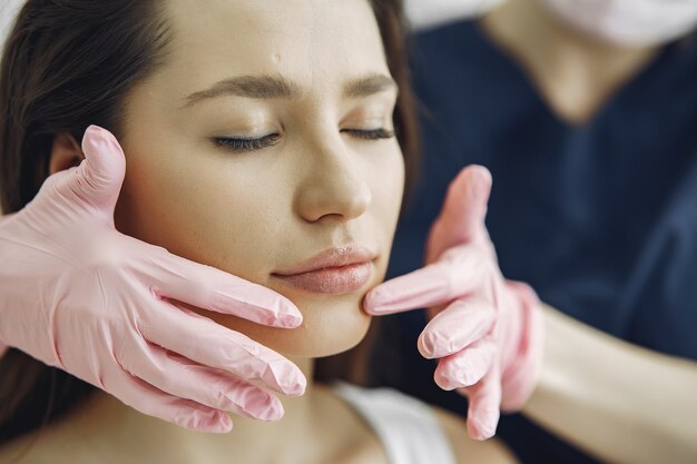 Woman with a doctor in cosmetology studio