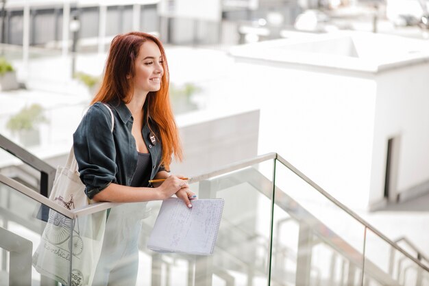 Woman with documents looking away