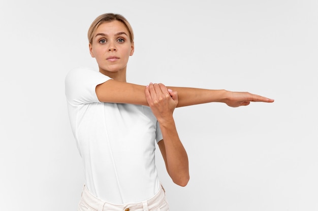 Free photo woman with doing physiotherapy with arms