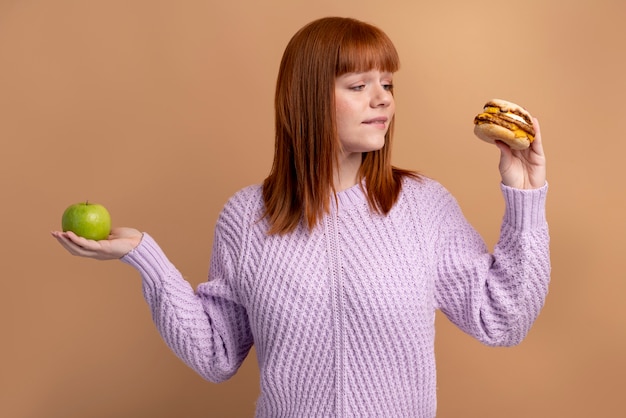 Woman with eating disorder deciding which food to eat