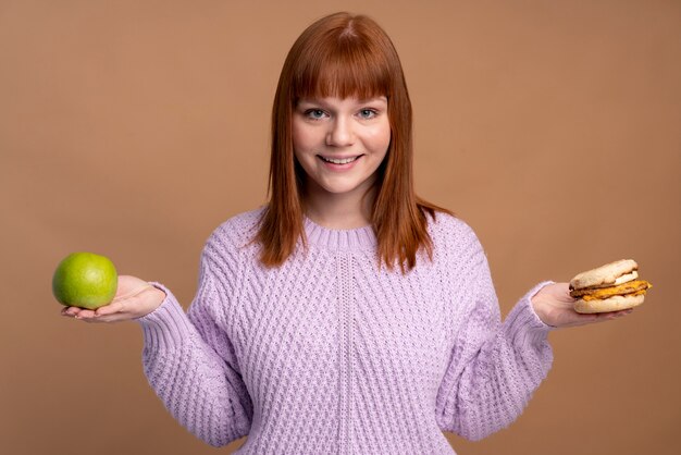 Woman with eating disorder deciding which food to eat