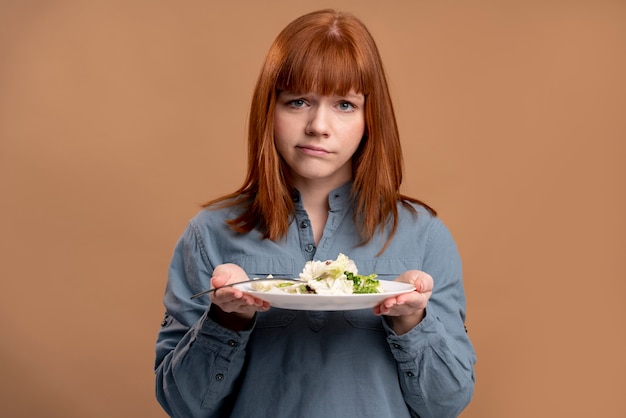 Foto gratuita donna con disturbo alimentare che cerca di mangiare sano