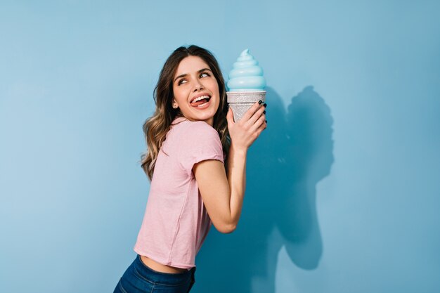 женщина с элегантной прической ест мороженое