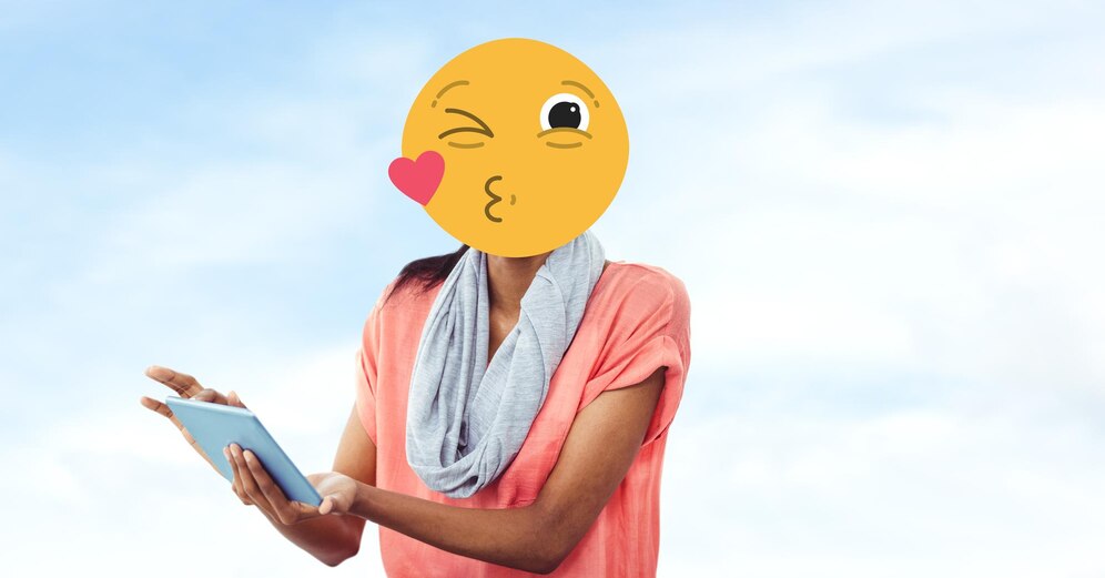 Premium Photo | Woman with emoji over face using tablet pc