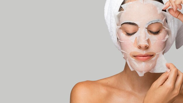 Woman with face beauty mask copy space