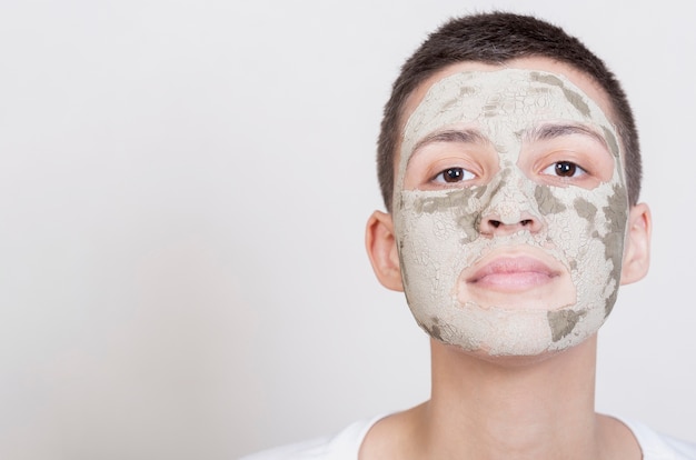 Foto gratuita donna con maschera viso guardando la telecamera