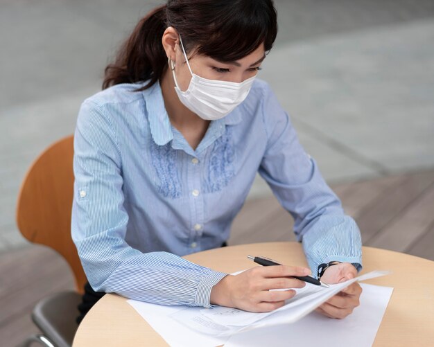 Woman with face mask at table